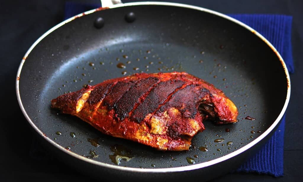 A picture of Mangalorean Chili, Salt and Vinegar Marinade + Fish Fry in a black pan.