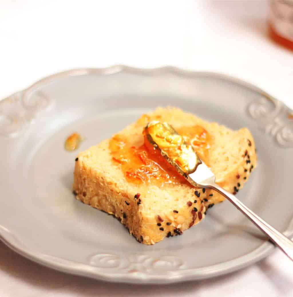 a picture of a slice homemade multigrain bread with a knife of jam