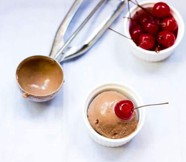 A picture of the Boozy Chocolate Ice Cream served in a white bowl with cherries.