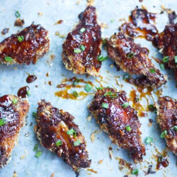 Baked Sticky Chicken Wings lined up on a tray.