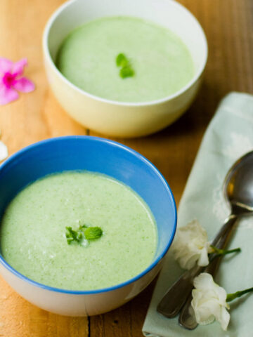 A picture of Chilled Cucumber Soup served in two bowls.