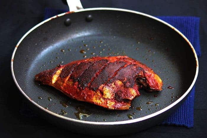 A shot of Mangalorean Fish Fry in a black pan