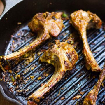 Spiced lamb chops in a pan.