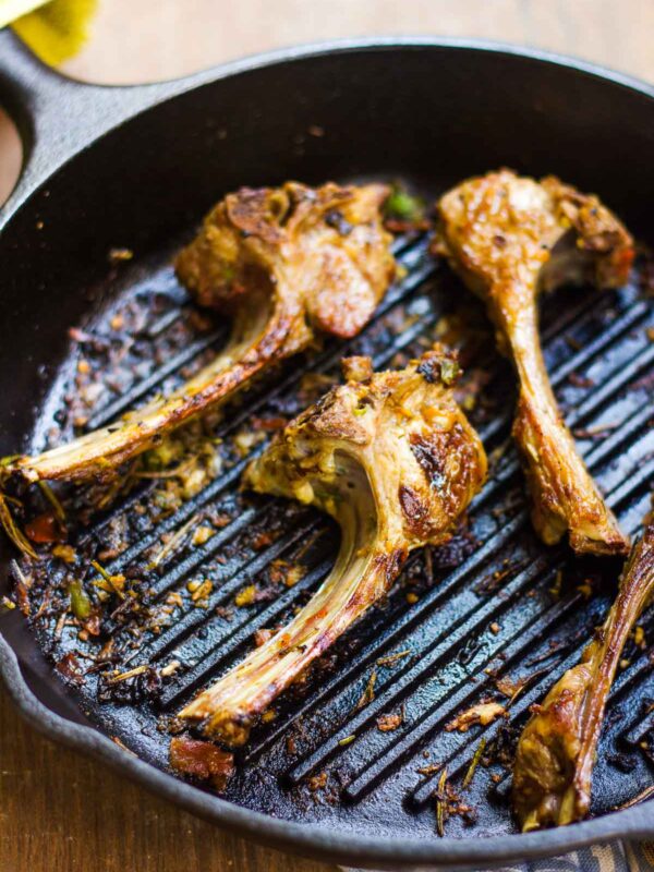 Spiced lamb chops in a pan.