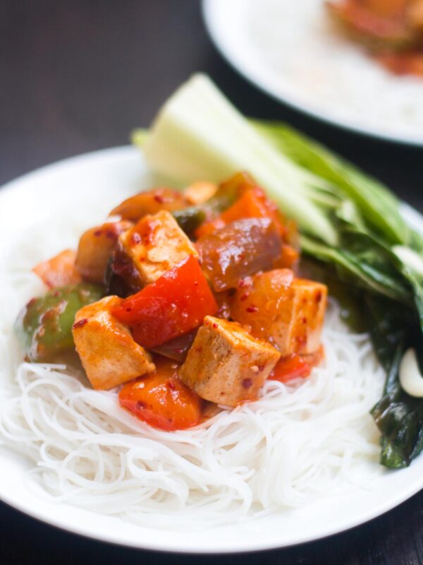 Sweet Chili Tofu Stir Fry served with noodles on a white plate.