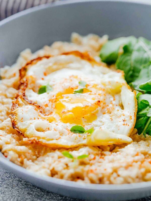 Savory Garlic Oats with served with Masala Fried Egg and basil- a lip-smacking breakfast.