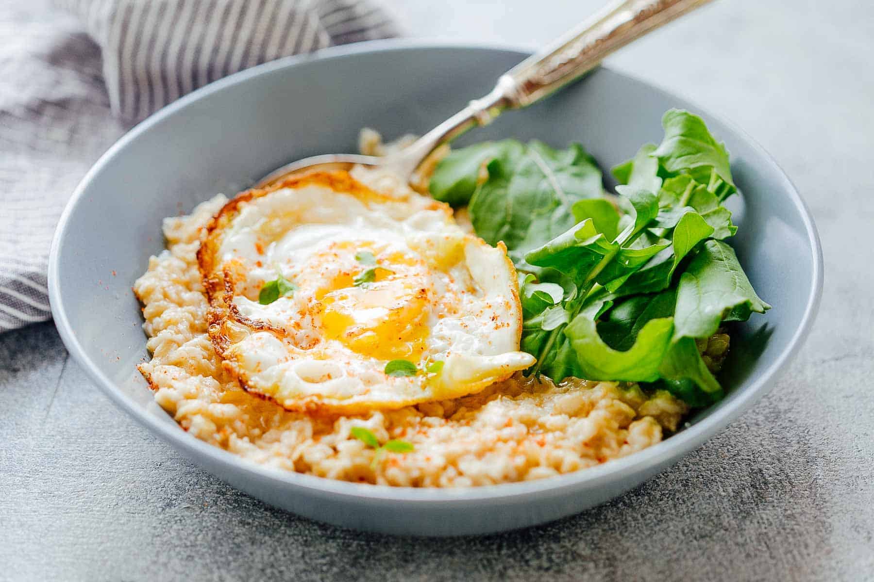 hese savory garlic oats with a masala fried egg are healthy, delicious and a great way to switch up breakfast when you are bored of regular sweet oatmeal. The runny yolk adds a gorgeous creaminess and the crispy edges add crunch. Make it a breakfast salad bowl with mixed greens or toss it up with some spices for a really satisfying breakfast.