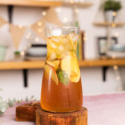 A pitcher of Virgin Apple Iced Tea with slices of apple inside