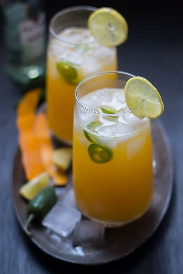 tall mango jalapeno fizzy cocktail served with ice and slices of lemon