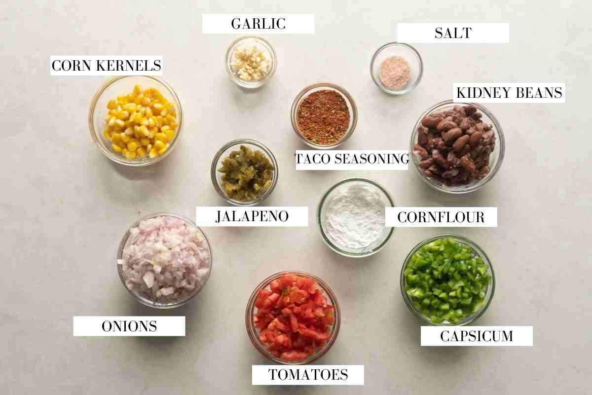 All the ingredients for vegetarian mexican soup pictured on a white background with text to identify them