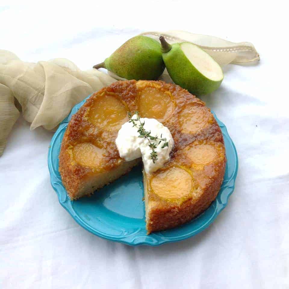 upside down pear cake served on a blue plate