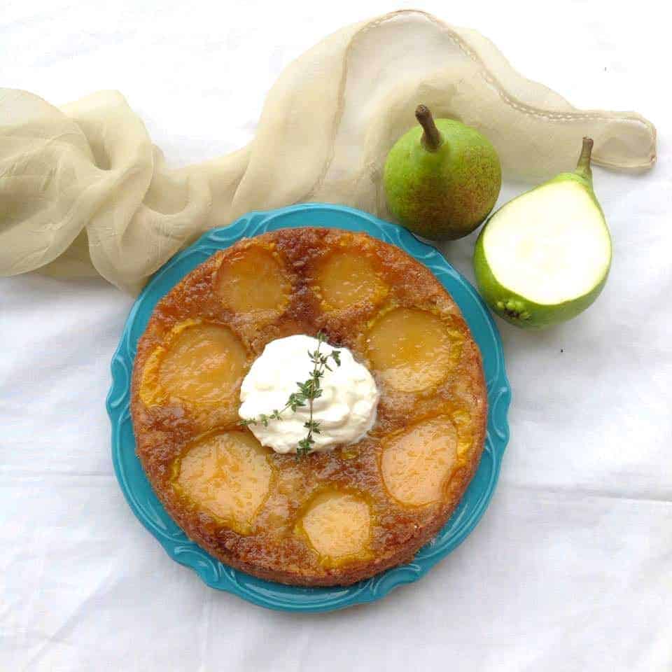 upside down pear cake served on a blue plate