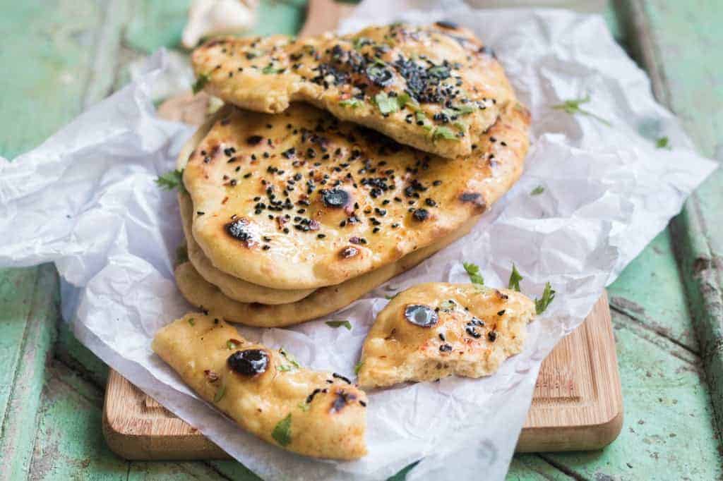Instant Naan bread recipe which doesn't require any yeast or eggs and takes only 30 minutes from start to finish and can be made on the gas stove in a skillet. No oven or tandoor.