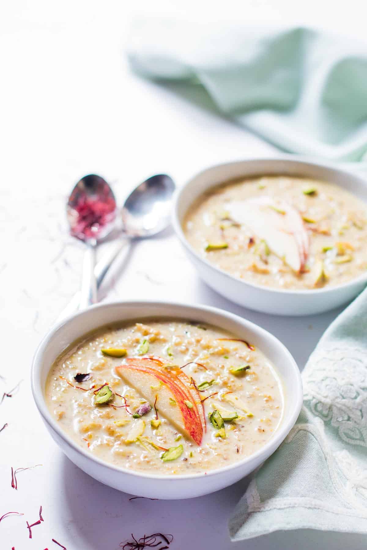 The Healthy Quinoa Apple Kheer topped with apple slices and chopped pistachios.