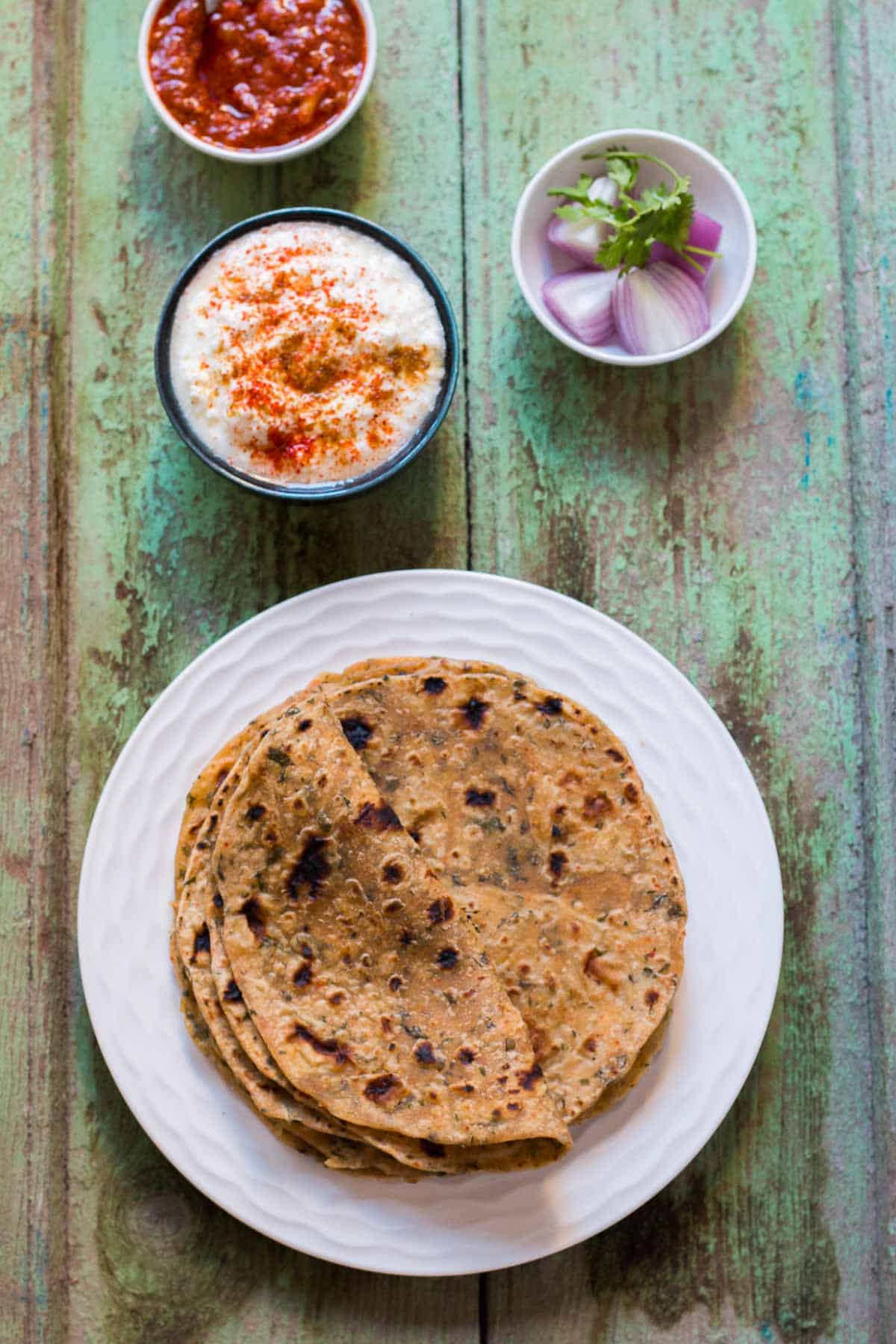 Kasuri Methi Parathas served with flavored curds, onions and some good ol' pickle!