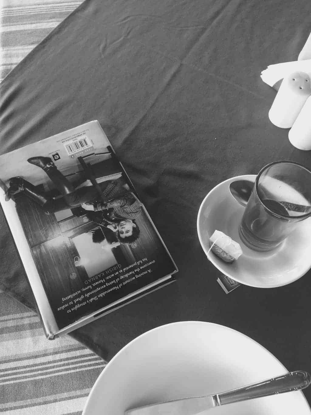 a picture of a book and a glass of tea placed on a table