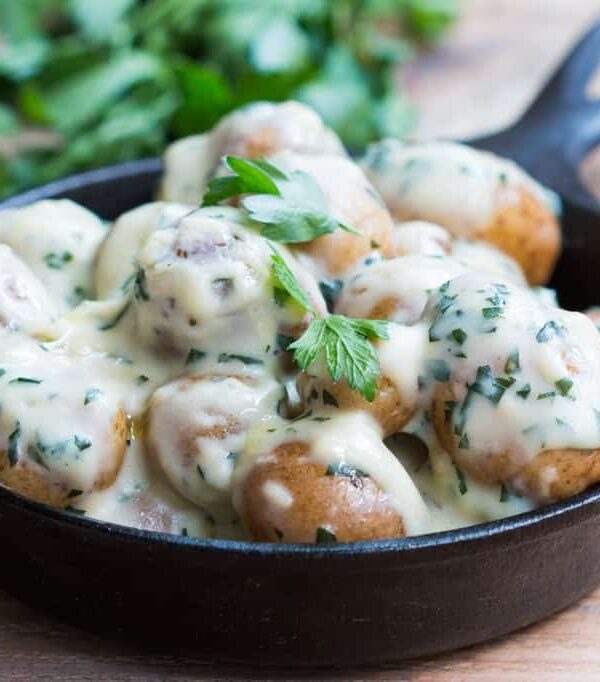 The Creamiest No Mayo Parsley Baby Potatoes in a black skillet.