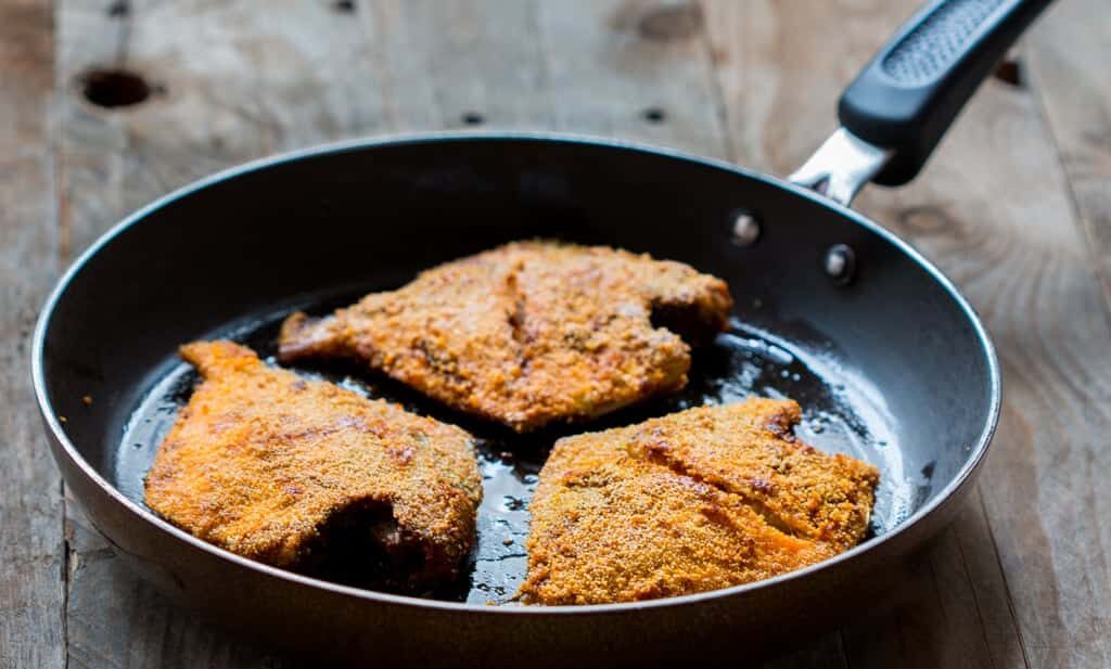 The fried fish coated with rava aka semolina in a pan.