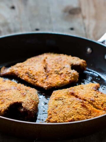 The fried fish coated with rava aka semolina in a pan.