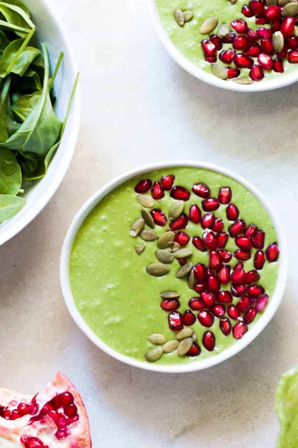 The smoothie bowl topped with pomegranate and pumpkin seeds