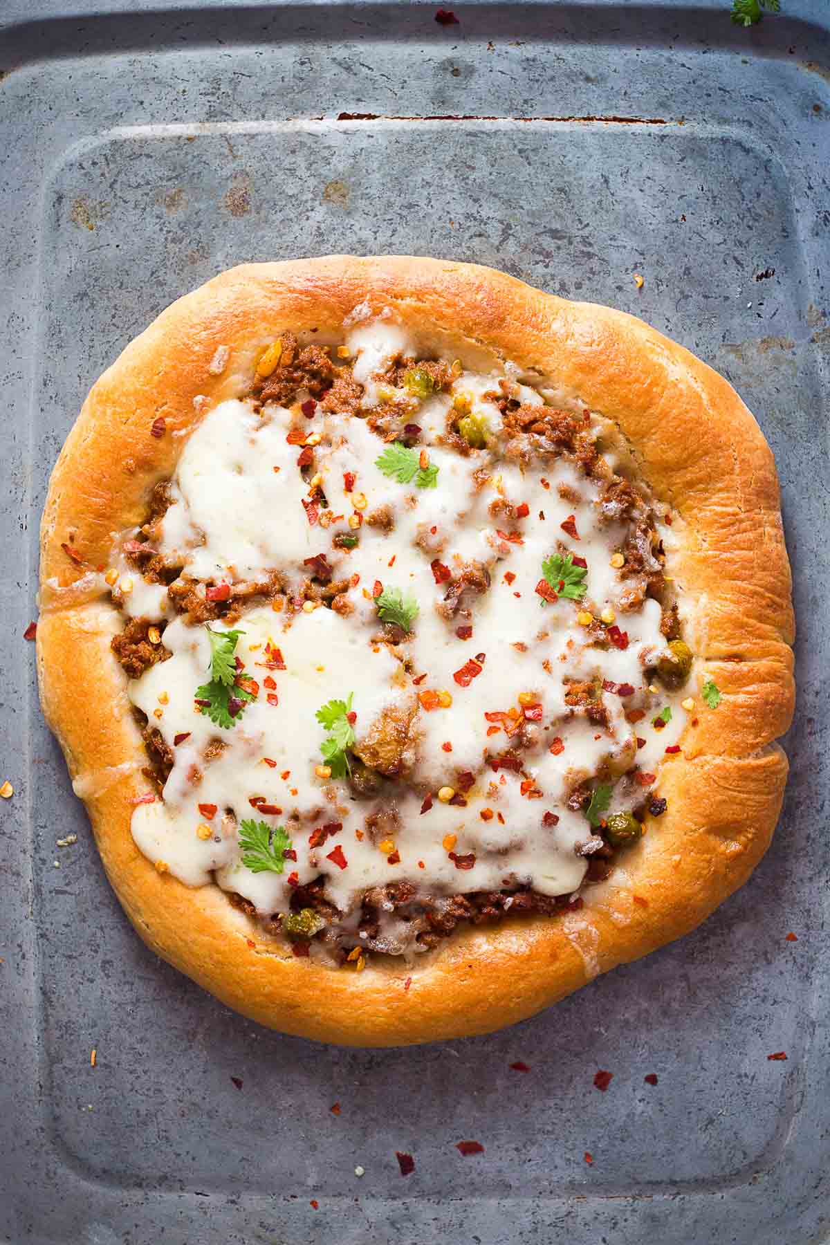 Wholewheat keema spiced minced lamb pizza in a tray