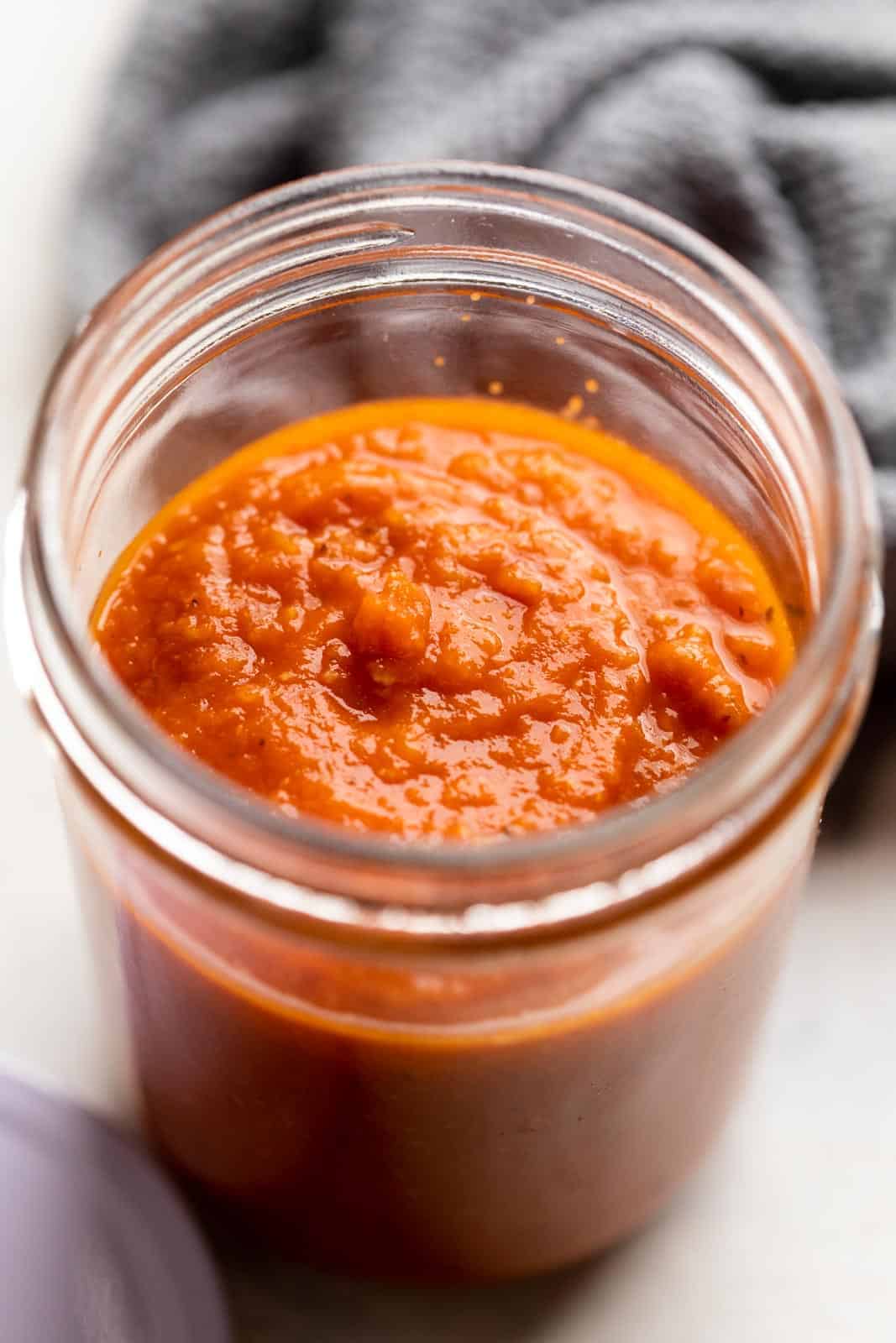 Cooked pasta sauce in a jar ready to be stored
