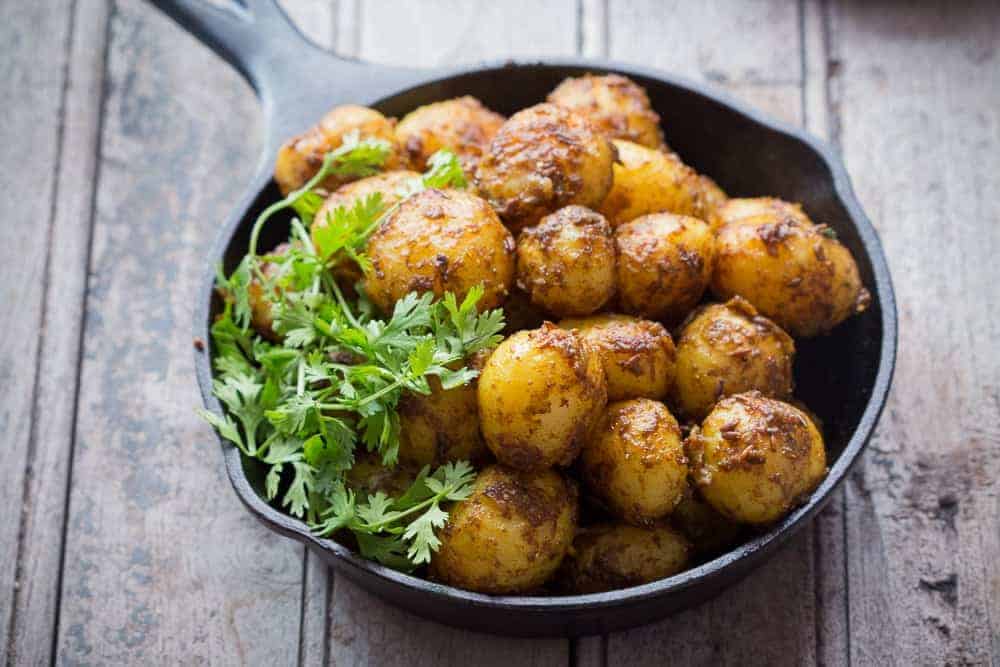 Bombay Potatoes are simply chatpate masala aloo. Coated with spices and ready in under 15 minutes, they double up as appetizer and main course.