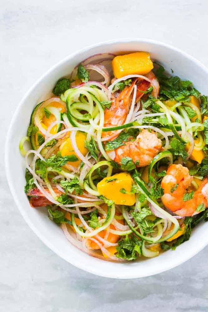 cucumber noodle prawn and mango salad served in a bowl