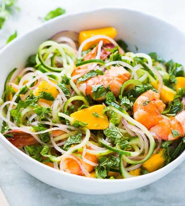 Cucumber Noodle Prawn and Mango Salad served in a white bowl.