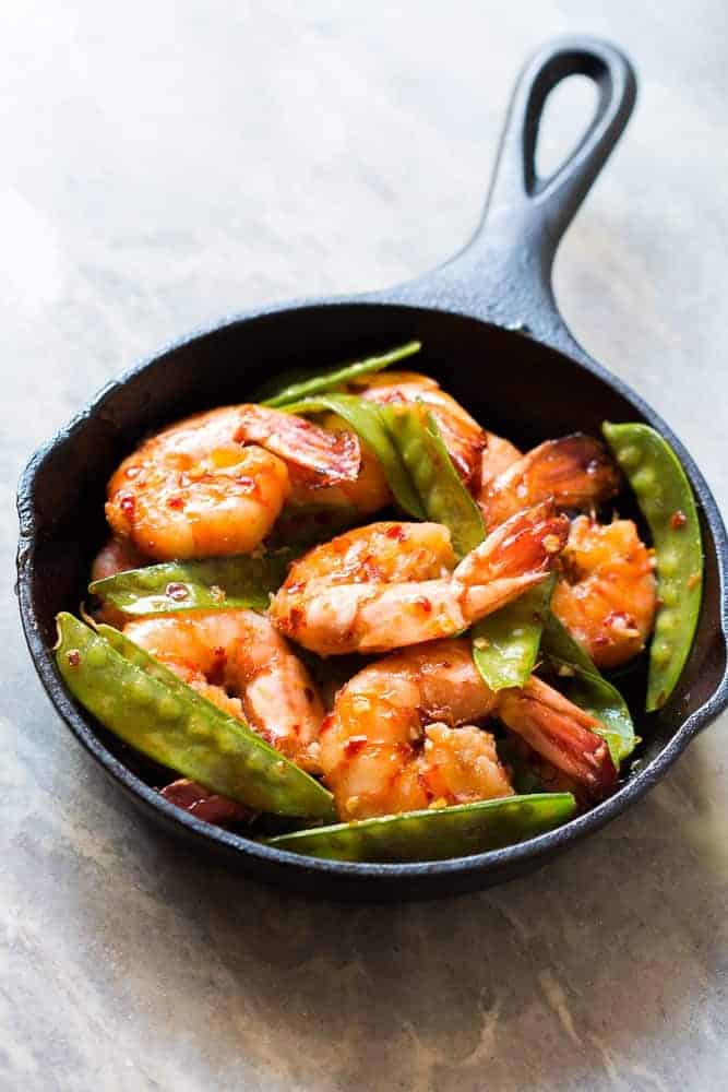 Looking for meals that take under 15 minutes? This is it - 5 ingredient honey garlic chilli jumbo tiger prawns! All the asian flavours you love in this one easy recipe! You can use shrimp, prawns or scampi and add whatever veggie you like - broccoli, bok choy, beans or even spinach! Soy free, gluten free, probably Whole30, Paleo and nut free!