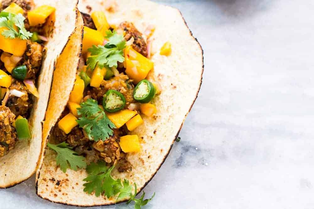 This recipe for super easy, healthy oats crusted fish tacos takes ONLY 15 mins. Use cod, tilapia, red snapper or any other white fish and top with cilantro mango salsa for extra zing!
