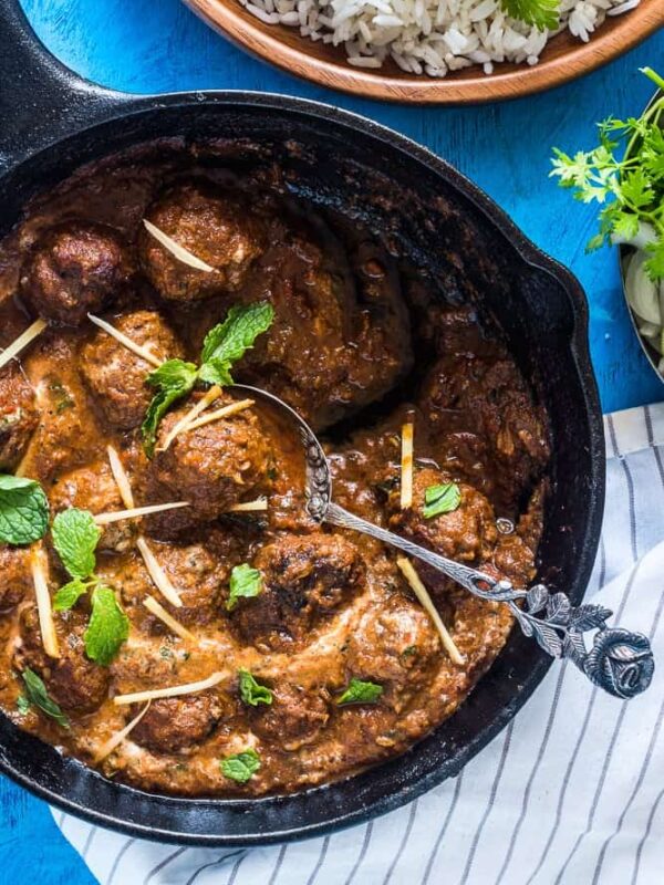 Easy One Pot Mutton (Lamb) Kofta Curry garnished with coriander and ginger and served alongside rice.
