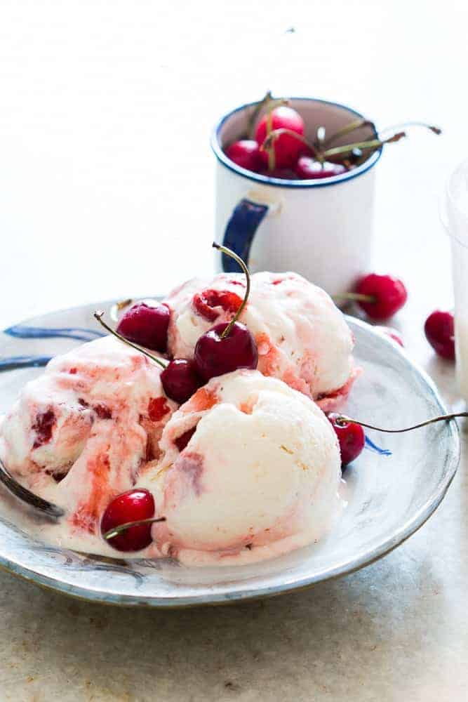 lychee cherry swirl icecream served in a plate topped with extra cherries