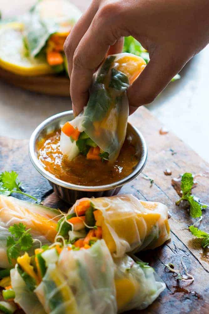These mango bell pepper rice paper rolls are the perfect summer food! They are stuffed with lots of amazing veggies and come with an insanely delicious mango cilantro dipping sauce! These are naturally gluten free, vegan and low carb!