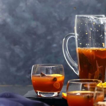 Non Alcoholic Mulled Wine served in a jug and poured into glasses.