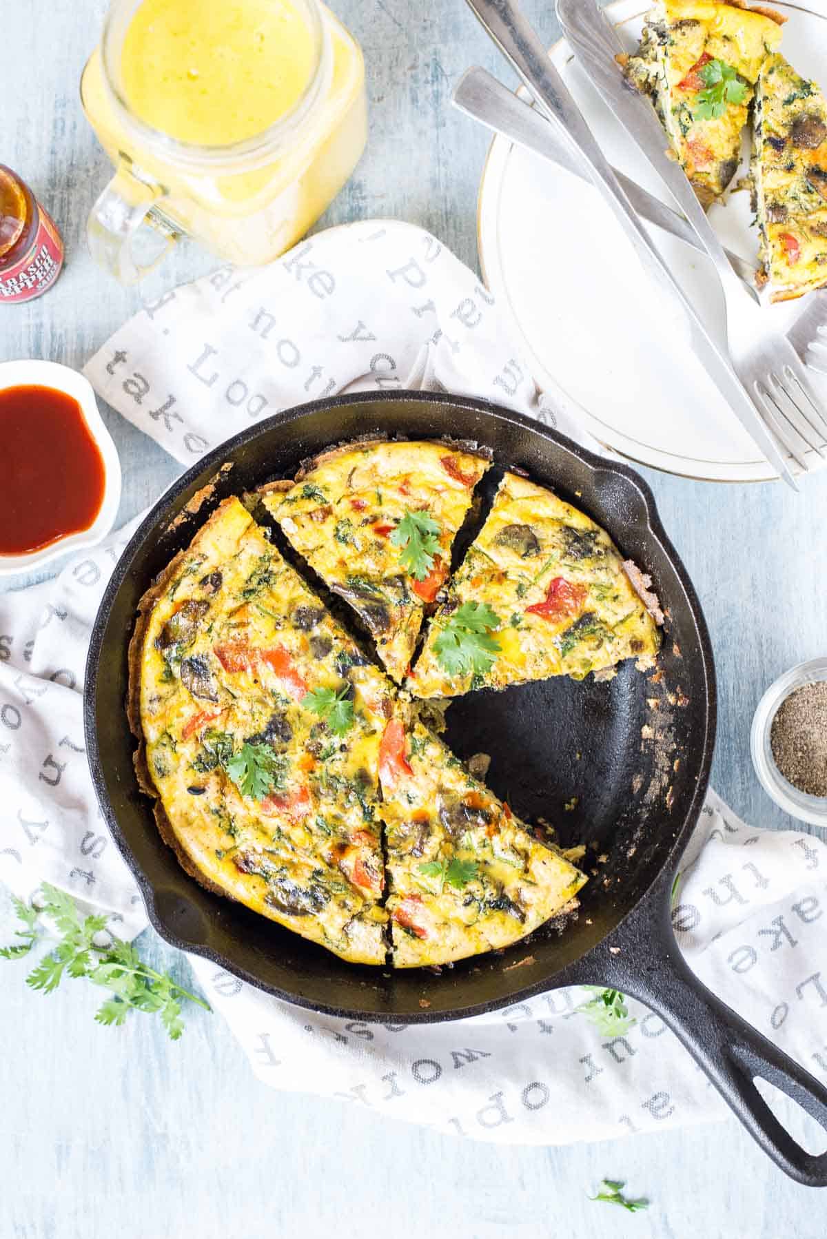 Slice of One Pan Indian Masala Omelette Frittata in a black pan