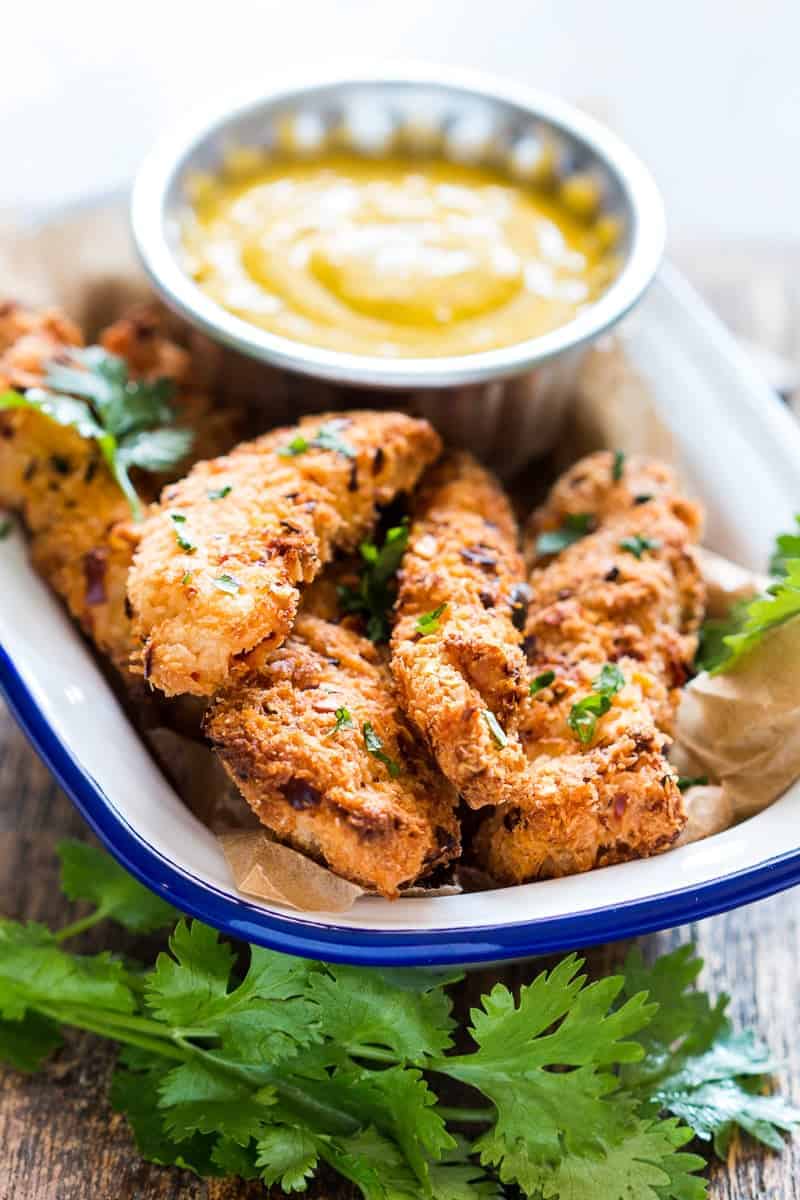 Easy recipe for super crunchy baked coconut crusted chicken tenders which are going to be a favourite at every party with kids and adults alike! Gluten free too.