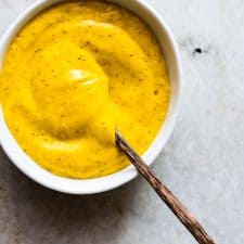The Blender Mango Mustard Dipping Sauce in a white bowl.
