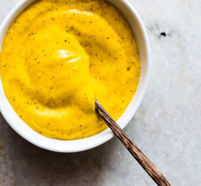 The Blender Mango Mustard Dipping Sauce in a white bowl.