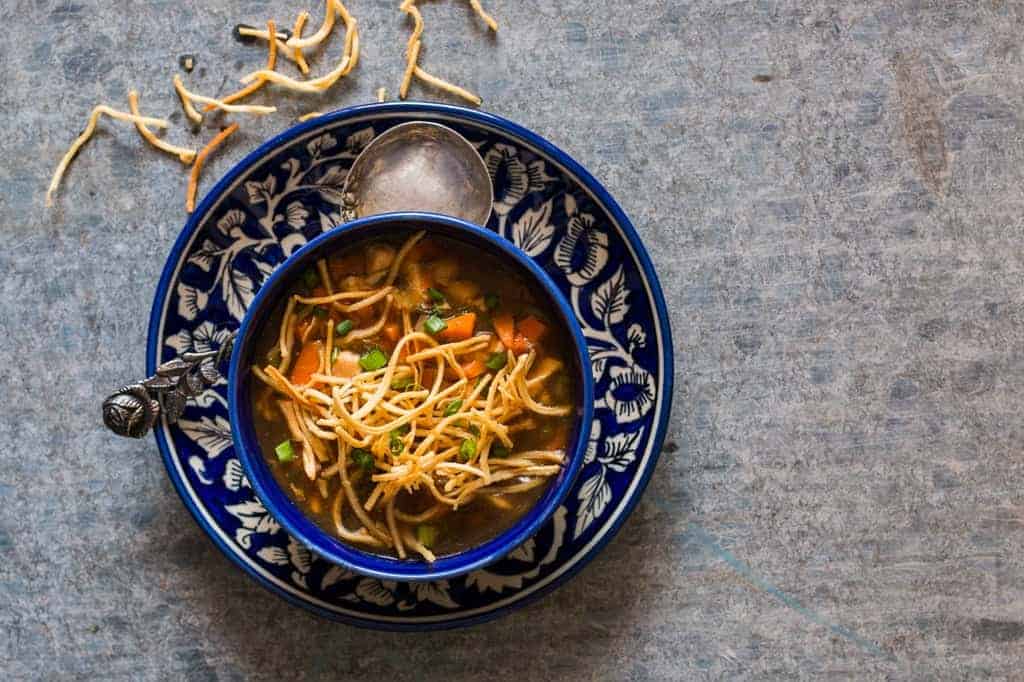 Chicken Manchow Soup is a spicy indo chinese soup, made popular by the street carts. This homemade version is an easy recipe and incredibly satisfying!