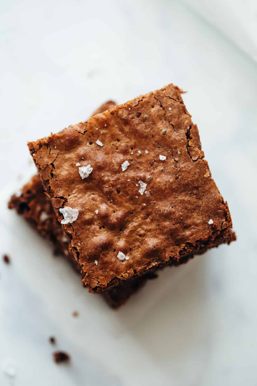 Chickpea Flour Brownies stacked one on top of the other topped with sea salt