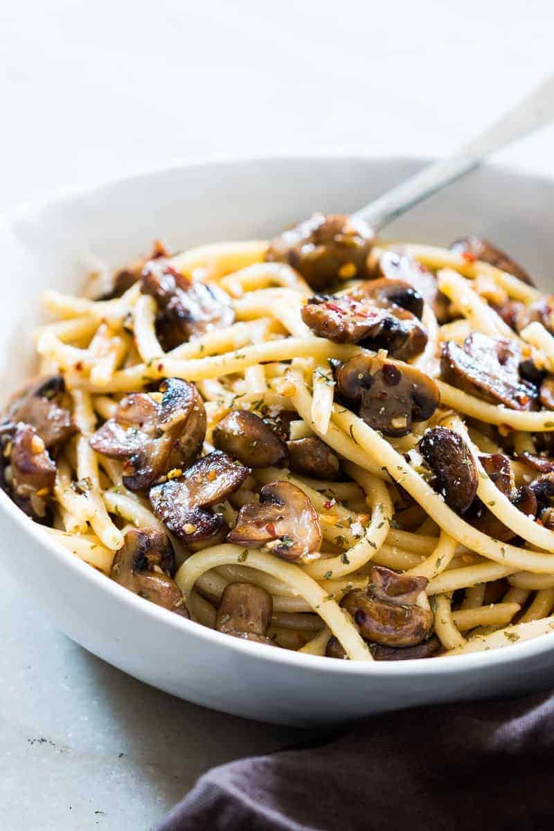 An easy, 15 minute recipe where the traditional spaghetti aglio olio e peperoncino is dressed up with sautéed mushrooms. We love this simple pasta sauce and even add chicken, bacon, anchovies or seafood to it. Perfect for meatless weeknight dinners and a hit with the kids! 