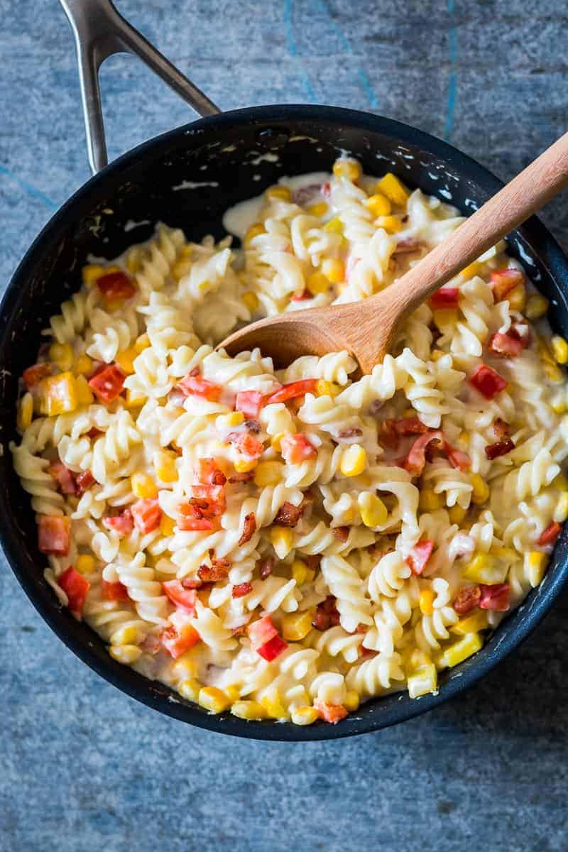 A lighter, creamier corn pepper fusilli alfredo so that you can have your fill without the guilt! There are some real substitutions with whole wheat flour, skim milk and half the cheese making the sauce.