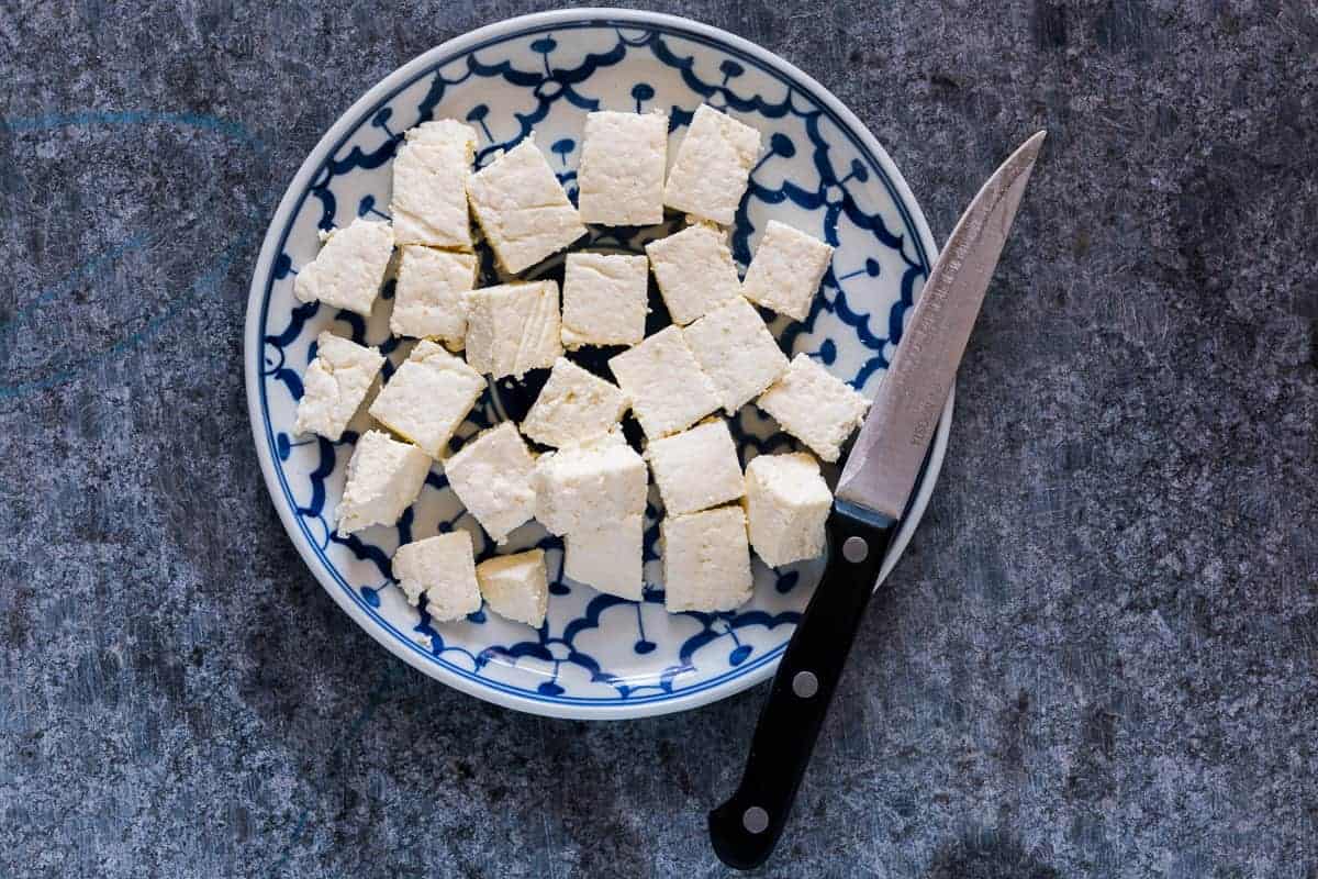 Here's step by step instructions to make homemade Indian paneer (cottage cheese) in just 15 minutes. The next time you want to make saag paneer, palak paneer, makhani, tikka or matar paneer, don't buy store bought and just make this at home with 2 ingredients.