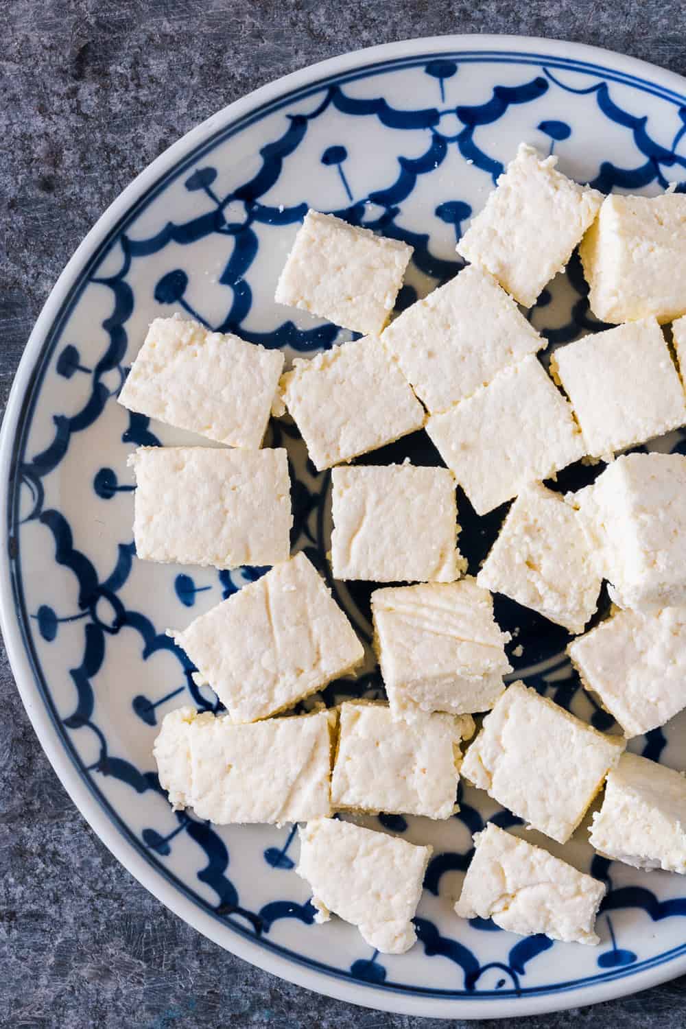 Here's step by step instructions to make homemade Indian paneer (cottage cheese) in just 15 minutes. The next time you want to make saag paneer, palak paneer, makhani, tikka or matar paneer, don't buy store bought and just make this at home with 2 ingredients. 
