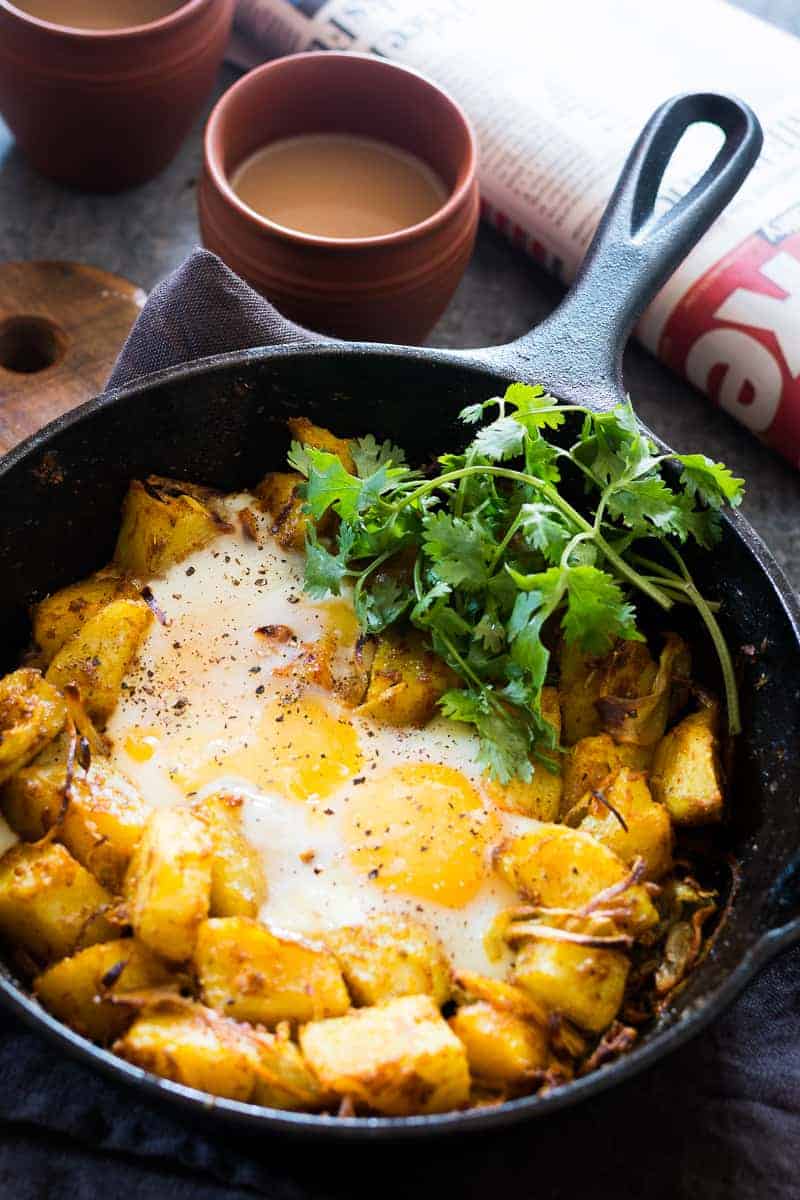 Spiced Indian Potatoes and eggs are cooked in a skillet for a hearty and easy holiday morning breakfast recipe. Perfect for a crowd, kid friendly and gluten free.
