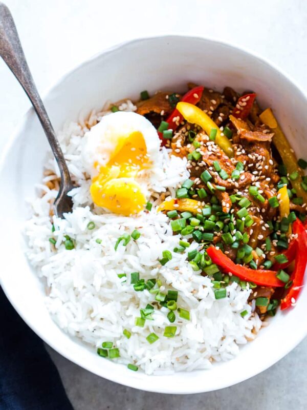 Slow Cooker Korean Pork Bulgogi with Gochujang served with egg and rice in a white bowl.