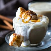 Homemade butterbeer latte topped with toasted marshmallows and served in a cup.