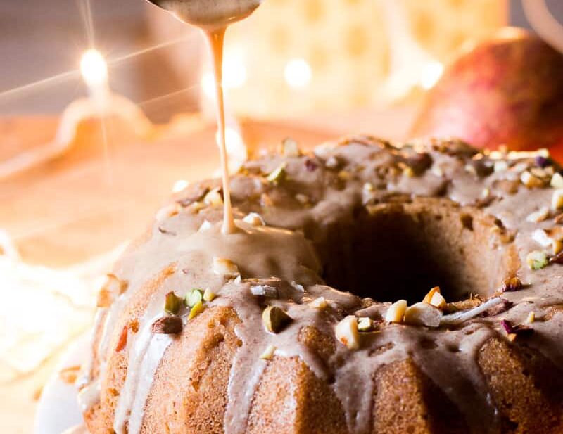 Garam Masala Eggless Apple Bundt Cake topped with a brown butter and rum glaze.