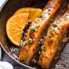Orange Mustard Salmon being seared in a pan.